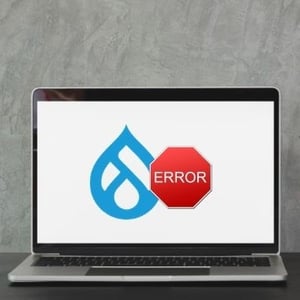 A laptop showcasing Drupal logo and error