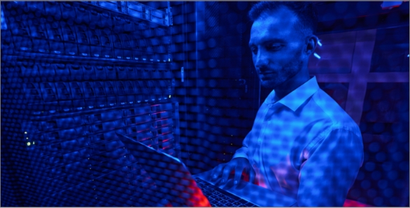 server-technician-doing-rack-examination-with-lapt-2021